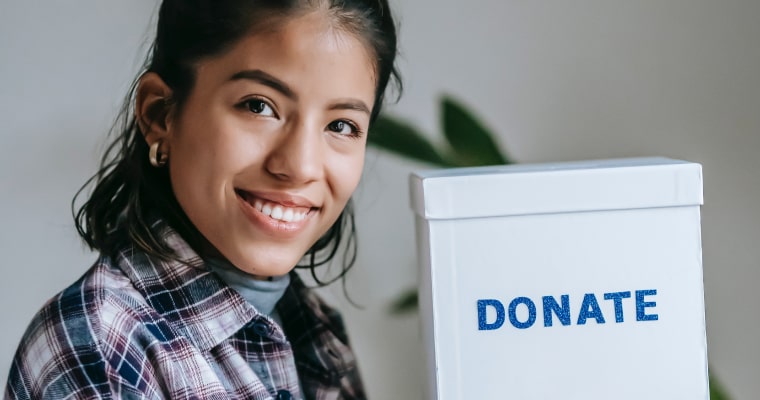 woman smiling donation box