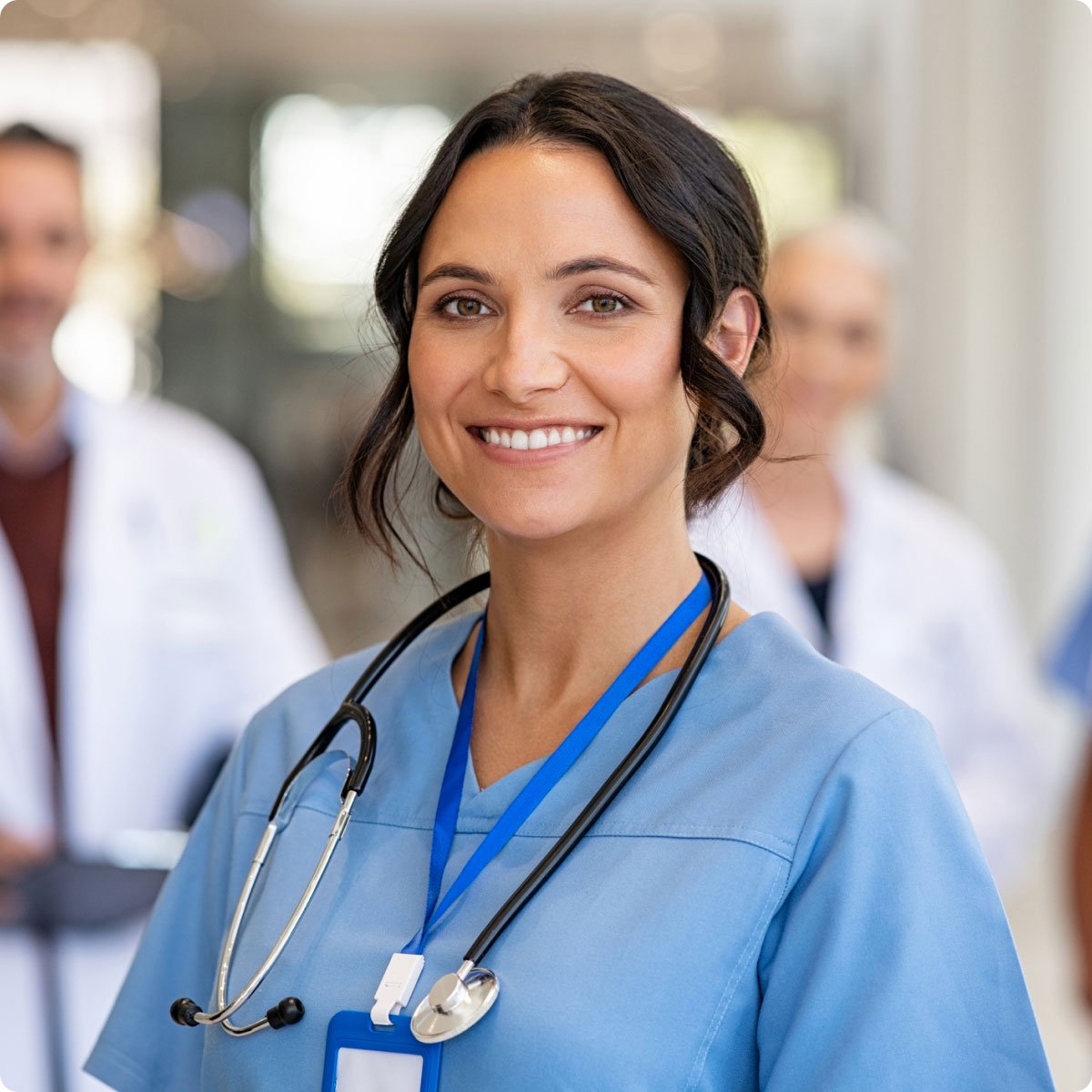 nurse smiling in hospital with doctors