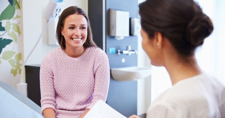 woman talking to doctor smiling