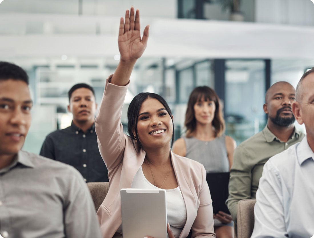 woman rising hand in meeting