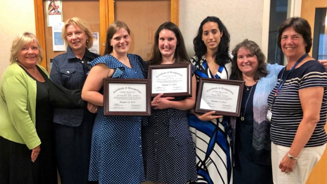 group of women holding diplomas